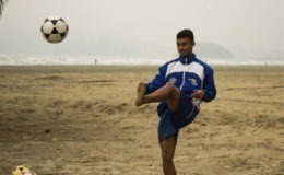 Footballer in blue and white jacket in savana